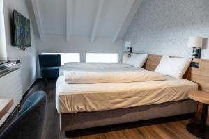 Voodi või voodid majutusasutuse Hotel Loge toas