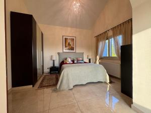 a bedroom with a bed and a window at Beach Villa Elena in Polis Chrysochous +44 photos