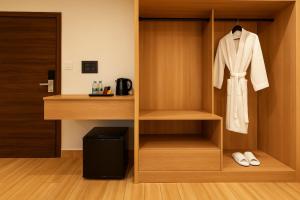a closet with a white robe and a door at Monte Verde at Rajpu Road by Zenvana in Dehradun