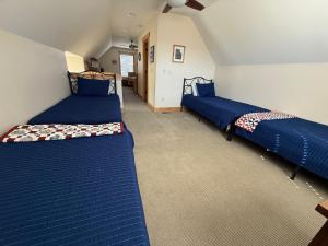 two beds in a room with blue sheets at Chinook & Carriage House #2 in Chelan +36 photos