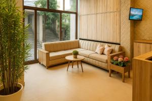 a living room with a couch and a table at Rosewood at Rajpur Road by Zenvana in Rājpur