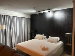 a bedroom with a bed with two towels on it at HOTEL SHOPPING VILA OLIMPIA in Sao Paulo +50 photos