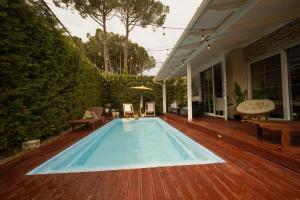 a swimming pool on a wooden deck at Ingrit Gjoni Villas in Draç