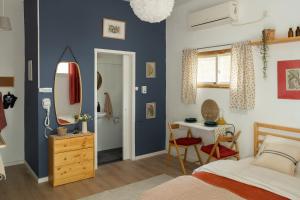 a bedroom with a bed and a table and a mirror at Dotan's Boutique Studios - By The Beach! in Tel Aviv