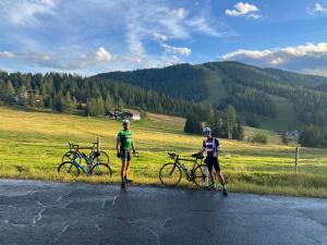 two people standing on the side of a road with bikes at #Kraftort_Nock-Loft in Sirnitz