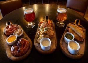 a table with two trays of food and two glasses of beer at InterContinental New York Times Square by IHG in New York