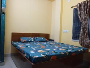 Postel nebo postele na pokoji v ubytování Rukmini Guest House