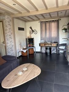 a living room with a couch and a table at Mijn Kleinhof in Westouter +20 photos