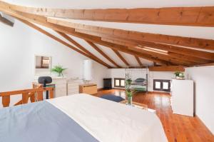 a bedroom with a white bed and wooden ceilings at La casina in Porrúa