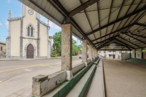 an empty building with a clock tower on a church at La casina in Porrúa
