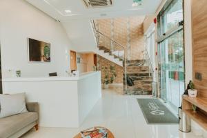 a living room with white walls and a staircase at Hotel do Sertão in Custódia