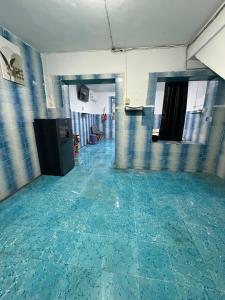 an empty room with blue tile flooring in a building at CasaAZUL in Progreso