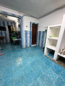 an empty room with blue tiled floors and a door at CasaAZUL in Progreso +1 photo