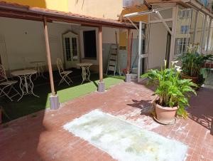 an outdoor patio with a table and chairs and plants at John's House in Sanremo