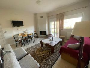 a living room with a couch and a table at Eftychia’s home-Σπίτι με θέα τη λίμνη Πλαστήρα in Ágios Athanásios