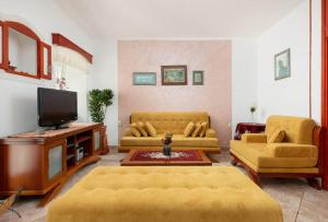 a living room with two couches and a flat screen tv at Branka R in Strp
