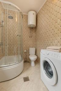 a bathroom with a washing machine and a toilet at Branka R in Strp +24 photos
