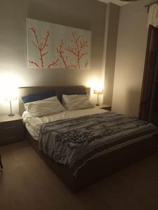 a bedroom with a large bed with two lamps at Dimora La Fenice in Licola +26 photos
