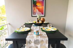 a black table with plates of food on it at Domaine Yacinthe in Le Robert