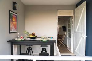 a kitchen with a table with a bowl of fruit on it at Domaine Yacinthe in Le Robert