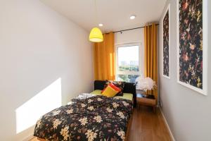 a small bedroom with a bed and a window at Apartament River Tower in Bydgoszcz