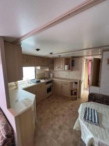 a kitchen with wooden cabinets and a counter top at Domki Olia in Choczewo