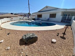 a small swimming pool in the yard of a house at Lakeview- Pool & Spa-Pet friendly- Boat parking in Lake Havasu City