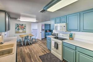 a kitchen with blue cabinets and a table with chairs at Lakeview- Pool & Spa-Pet friendly- Boat parking in Lake Havasu City