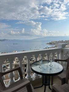 Una mesa en un balcón con vista al mar. en Tote's Sea View Apartament, en Sarandë 16 fotos más