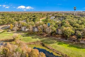 an aerial view of a home with a pond at Sea Trail Golf Beach 2Br 2Ba in Sunset Beach