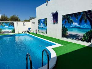 a swimming pool in front of a house at La Casa del Flamenco in Cañada del Rabadán