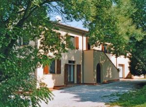 a large house with trees in front of it at Agriturismo La Serra in Cenaia
