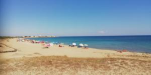 a group of people on a beach with the ocean at Stellasalentina in Torre Colimena