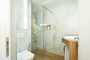 a bathroom with a shower and a toilet and a sink at The blue pearl apartment 2 in Durrës +31 photos