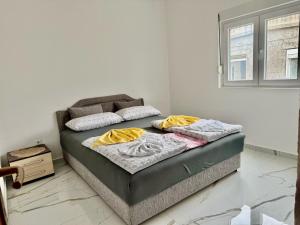 Postel nebo postele na pokoji v ubytování Apartmani Gusani