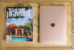 Un iPad y una revista junto a un libro. en Casa Penchita, en Santa Cruz de Tenerife