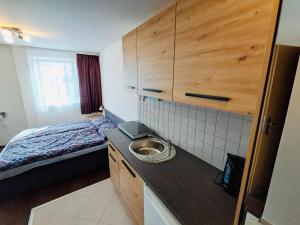 a small bathroom with a sink and a bed at Štaindlův kopec in Rapšach