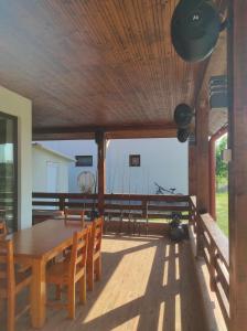 a dining room with a wooden table and chairs at Casa Valurile Marii in Sfântu Gheorghe +28 photos