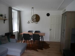 a living room with a table and chairs and a couch at renovierte Altbauwohnung im Oberallgäu in Immenstadt im Allgäu