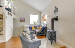 a living room with two couches and a stove at Scenic and Cozy Sweet Northern Comfort in Homer! in Homer