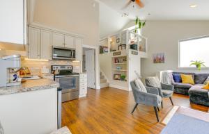 an open kitchen and living room with a couch at Scenic and Cozy Sweet Northern Comfort in Homer! in Homer