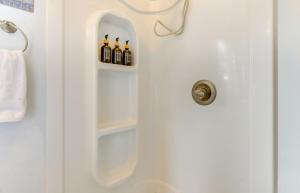 a bathroom door with three bottles of wine at Scenic and Cozy Sweet Northern Comfort in Homer! in Homer +17 photos
