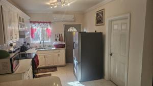 a kitchen with a refrigerator in the middle of it at palmview estate townhouse in Mammee Bay