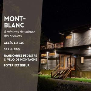 a sign in front of a house at night at Maison contemporaine Tremblant- Spa & tranquillité in Lac-Superieur