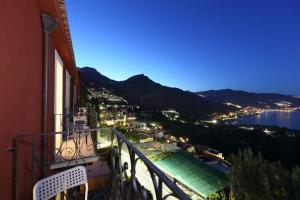 a balcony with a view of a city and the water at Villa Astoria in Taormina