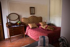 a bedroom with a bed with a mirror and a dresser at Villa Ida Bed & Breakfast in Terracina