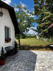 a patio with a bench next to a house at Terrazzo house in Subotica