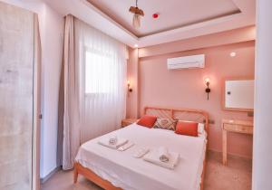 a bedroom with a bed with towels on it at Happy Kaş Apart in Kaş