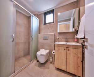 a bathroom with a toilet and a shower and a sink at Happy Kaş Apart in Kaş