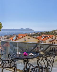 a table and chairs on a balcony with a view at Happy Kaş Apart in Kaş